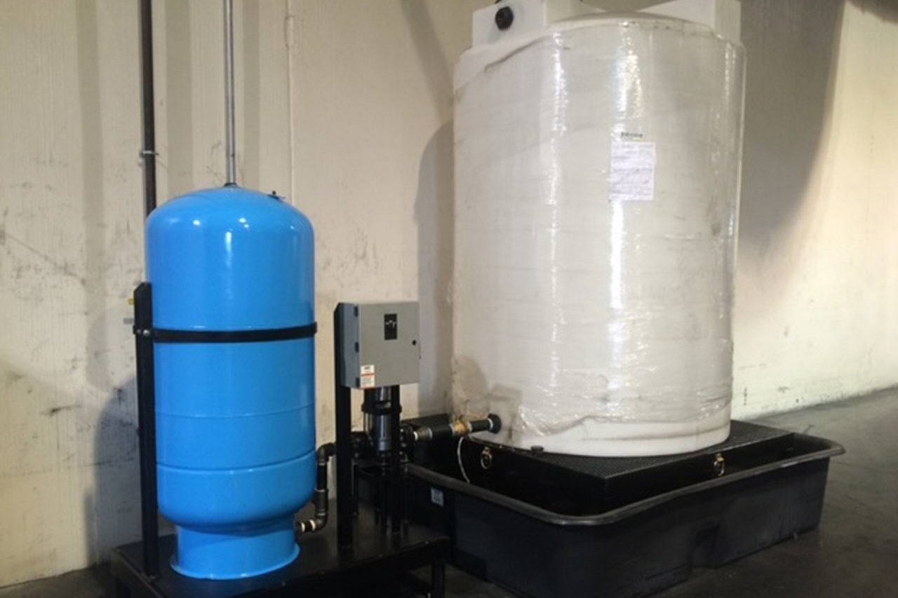 blue tank and white tank connected by custom process piping
